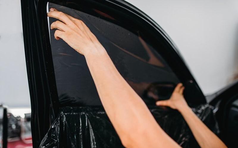 Close view of a window film edge during installation