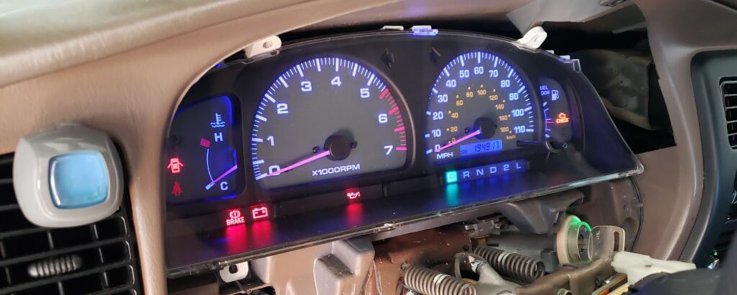 Instrument cluster with illuminated gauges and surrounding trim removed