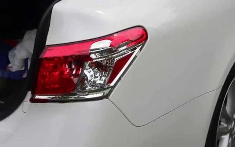 Rear combination lamp fitted to a white car