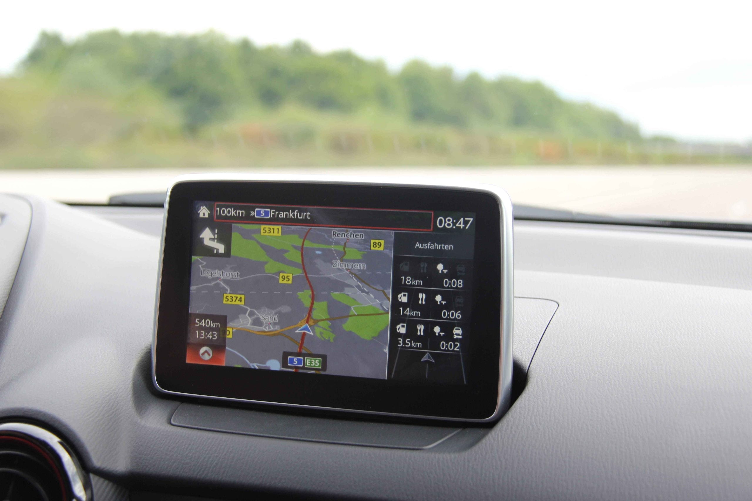 Factory navigation display showing a route in a vehicle dashboard