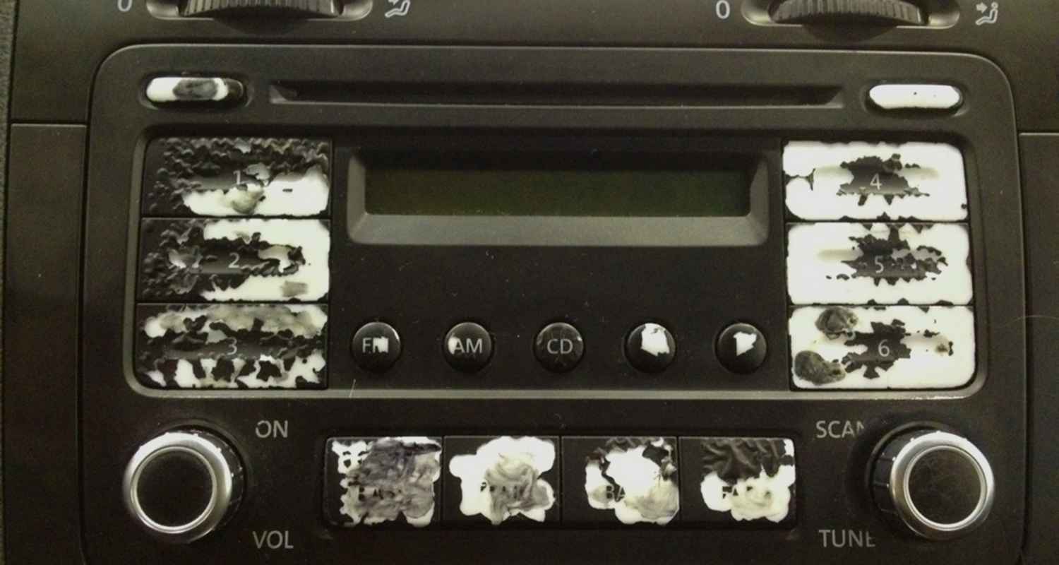 Worn radio control buttons with peeling symbols