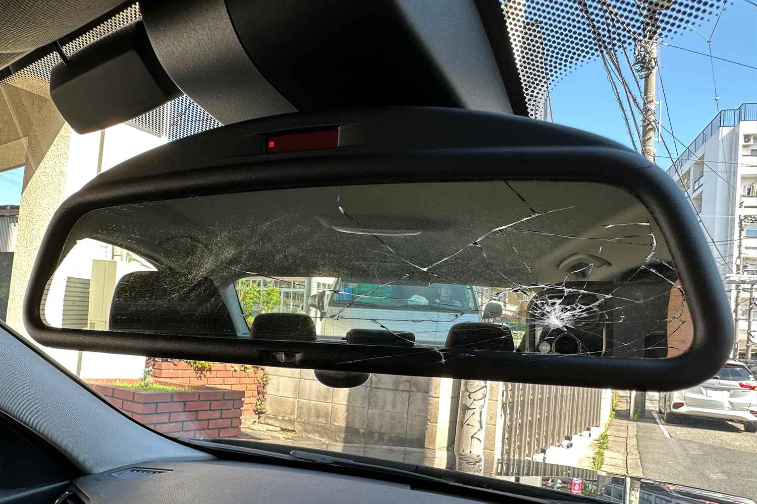 Interior rear view mirror with visible damage inside a car