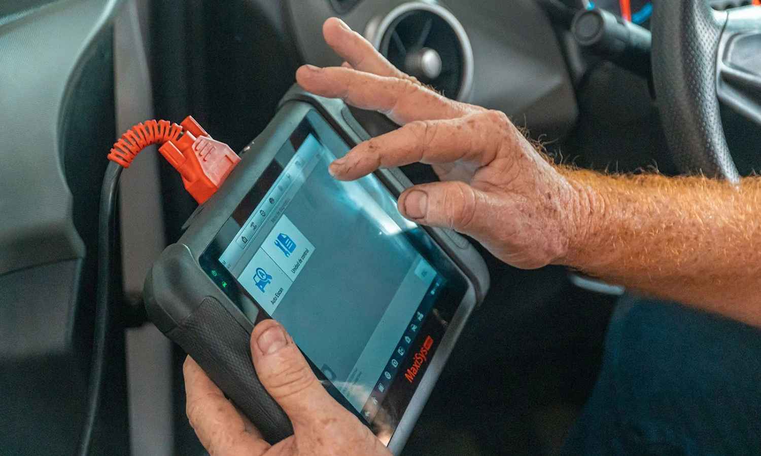 Diagnostic equipment being used inside a car
