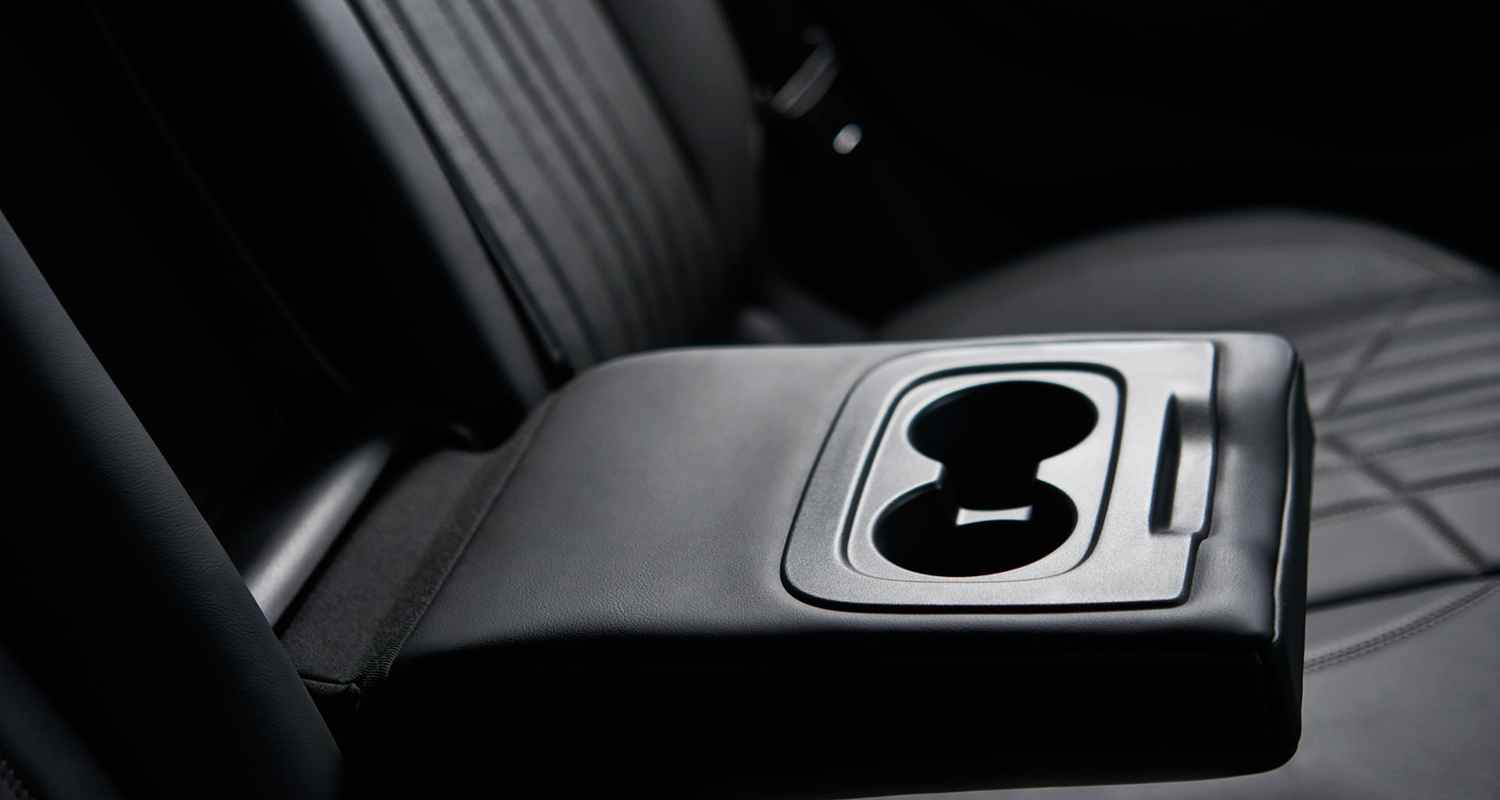 Twin cup holder assembly in a rear center armrest