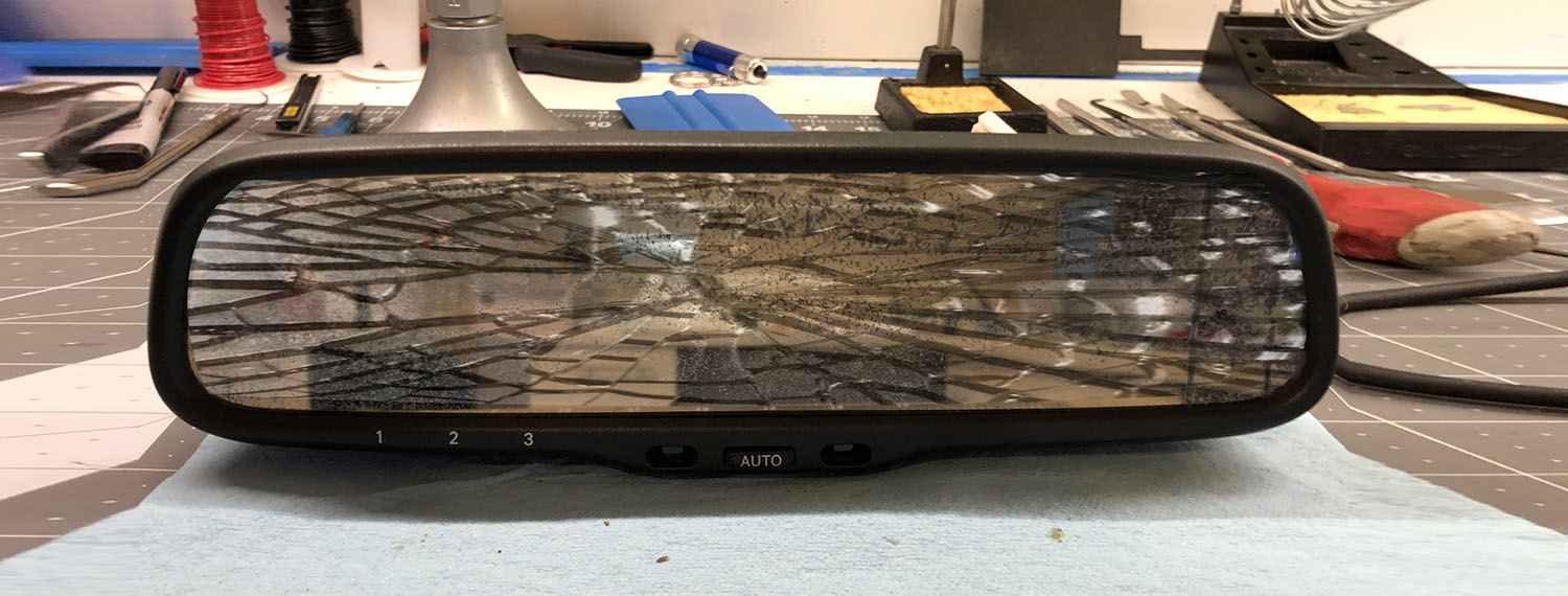 Damaged interior rear view mirror removed from its mounting
