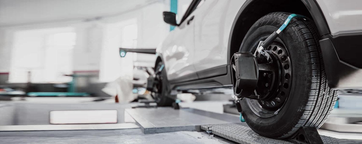 Wheel alignment target fitted to a car wheel in a workshop