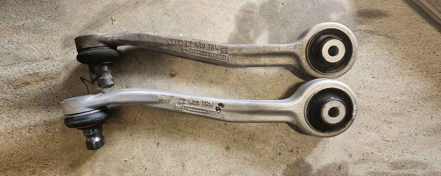 Two suspension control arms with bushings and joints