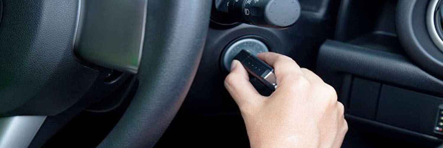 A hand turning a key in a car ignition