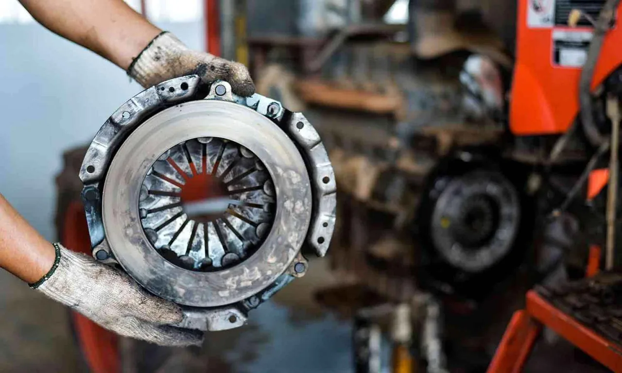 Clutch pressure plate being handled during replacement