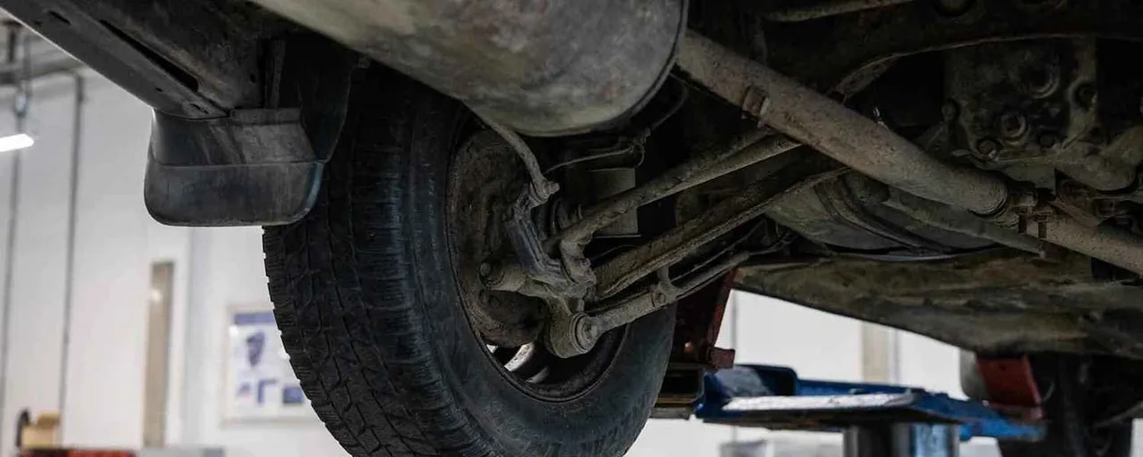 Suspension control arm and wheel on a vehicle lift