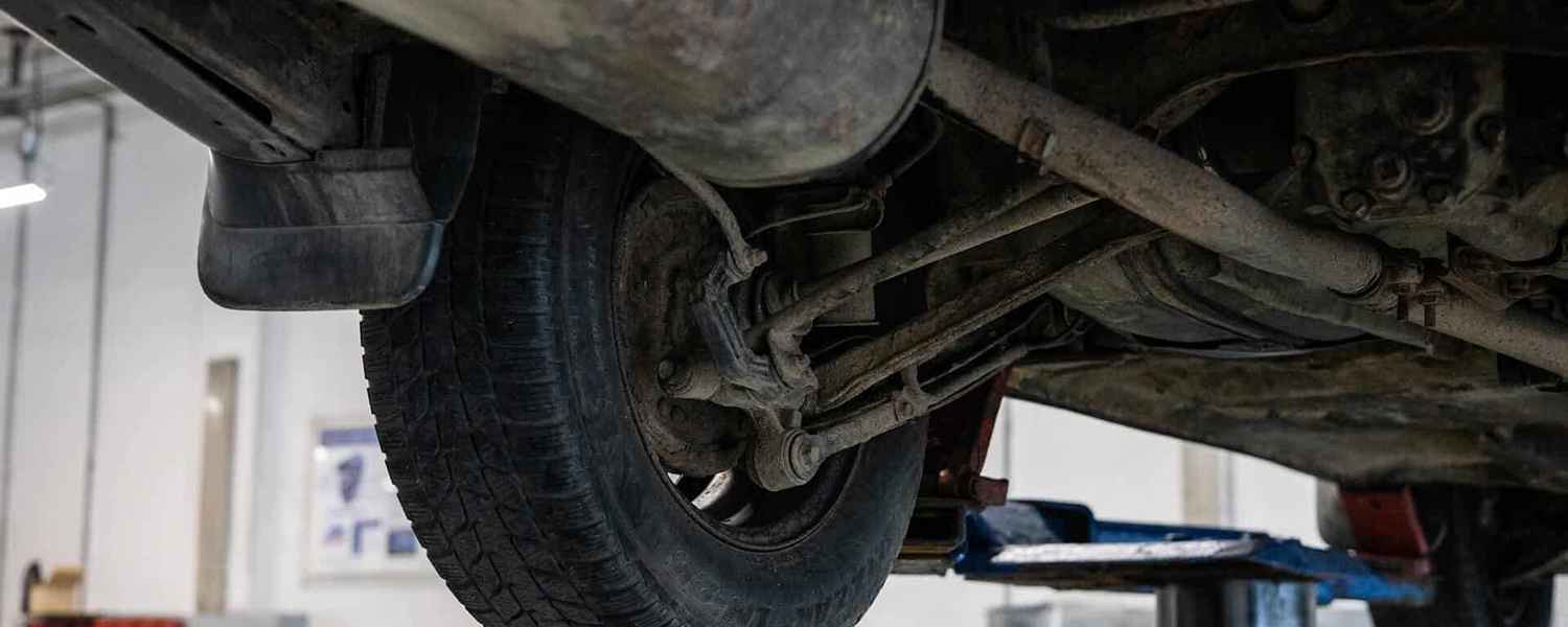 Suspension control arm and wheel on a vehicle lift