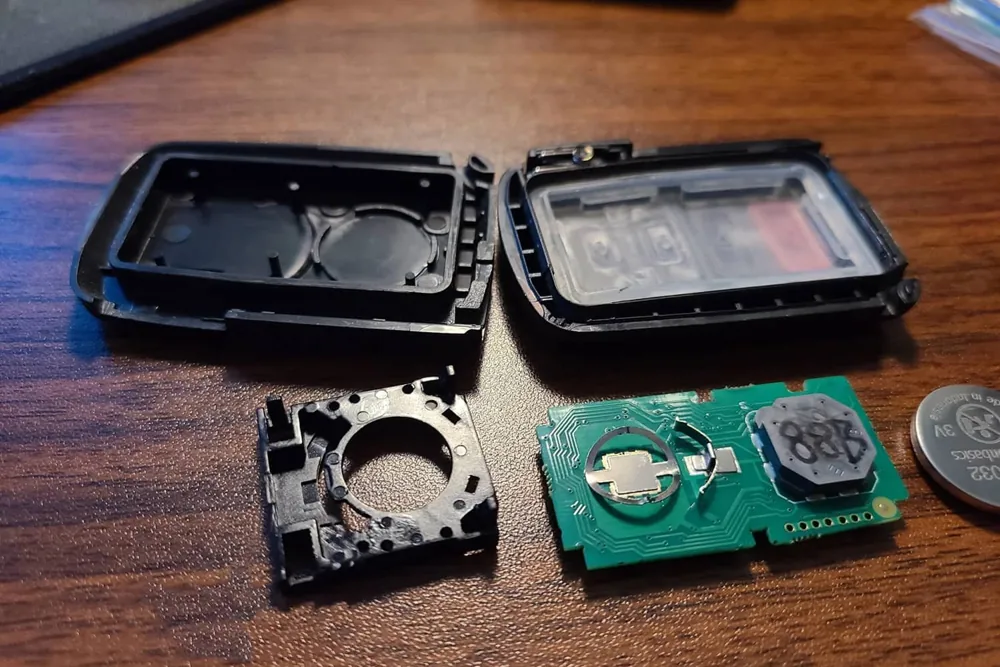 Coin-cell battery holder and circuit board inside an opened key fob