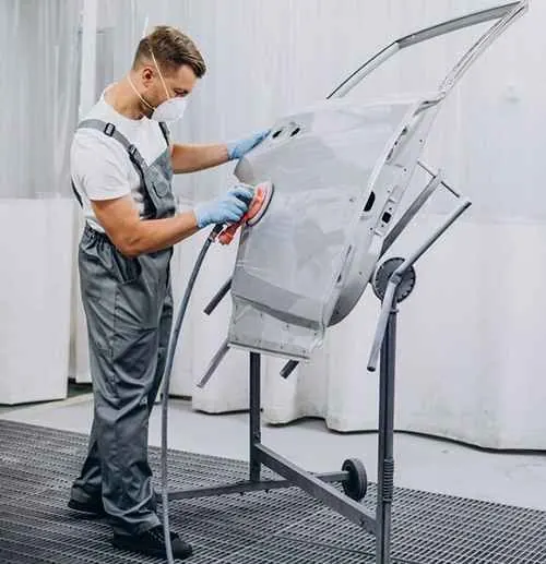 Preparing a primed door panel with a sanding tool