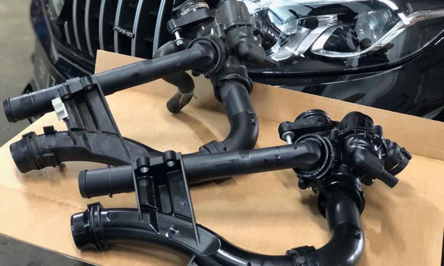 Coolant thermostat housing assembly on a workbench