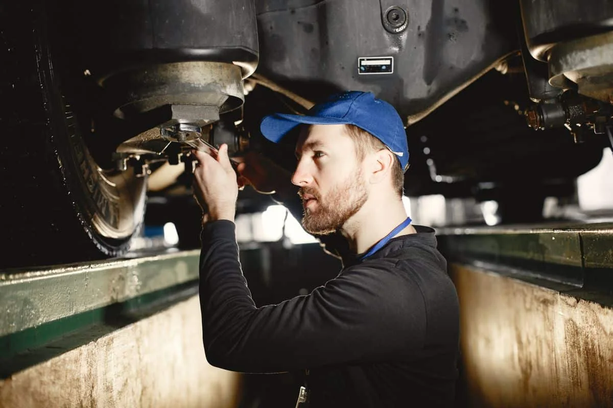 Used car underbody checked on a lift during a pre-purchase inspection